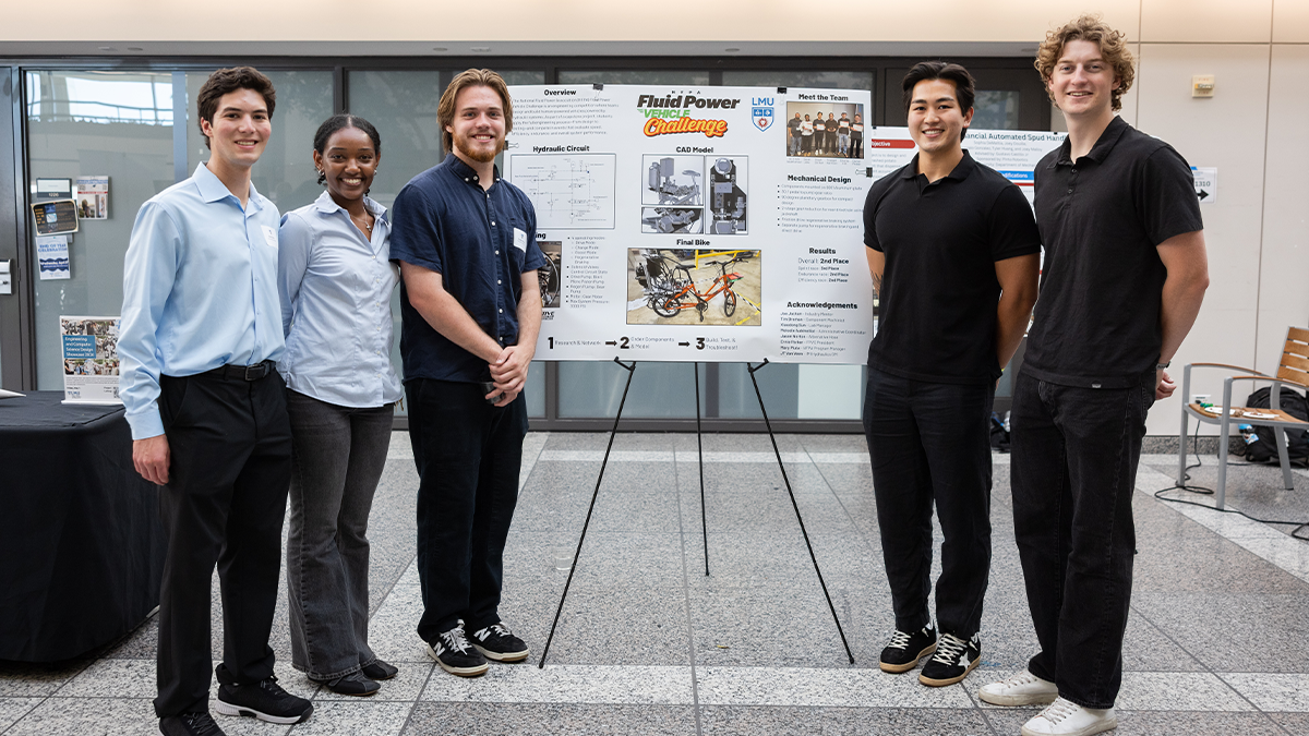 Engineering students showing their poster on Fluid vehicle project